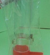 Tube feeder with metal clip